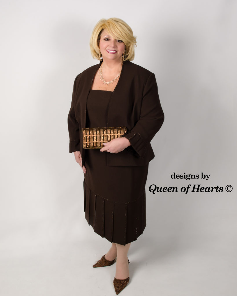 a woman wearing a brown dress with a jacket